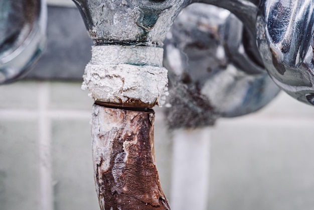 Old rusted disgusting faucet Toned in cold colour photo of old tap covered in rust calx