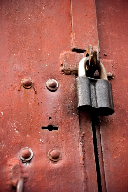 Old rusted lock on a brown gate