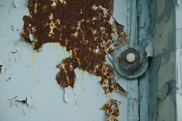 on the old rusty door the bell is nearby