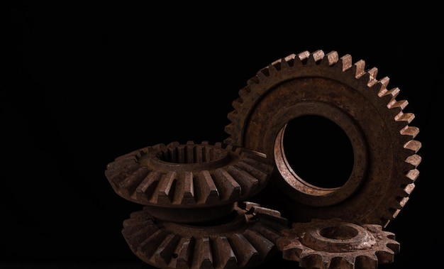 Old rusty metal gears on a black background closeup