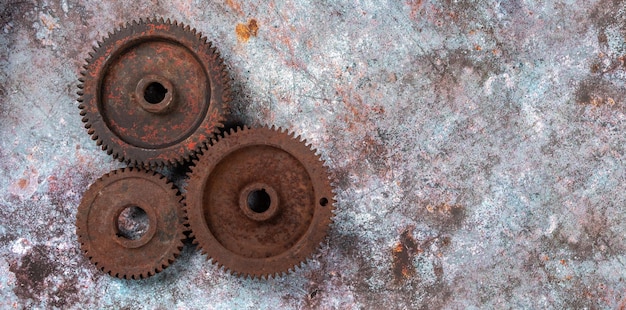 Old rusty metal gears on a rusty textural background