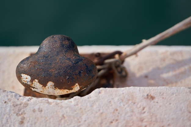 Old and rusty ship mooring with rope seen from above in the port