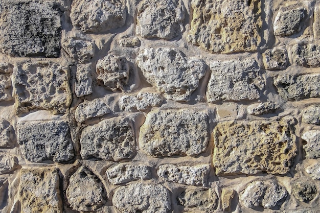 Old sandstone brick wall closeup High resolution photo