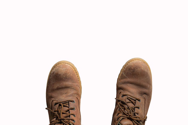 Old scuffed hiking boots isolated on white background