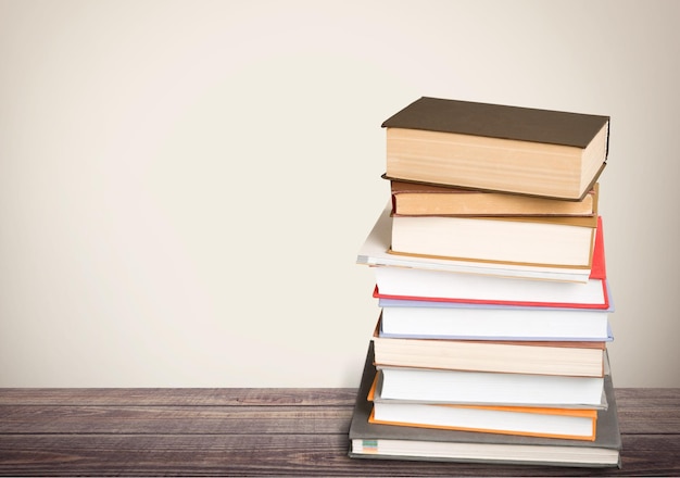 Old stacked books on wooden background