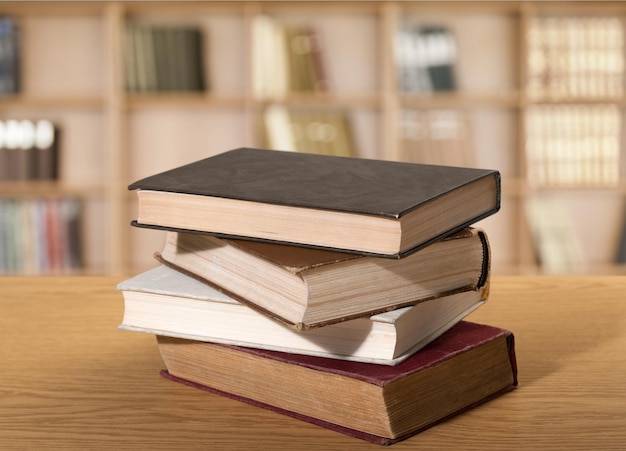 Old stacked books on wooden table