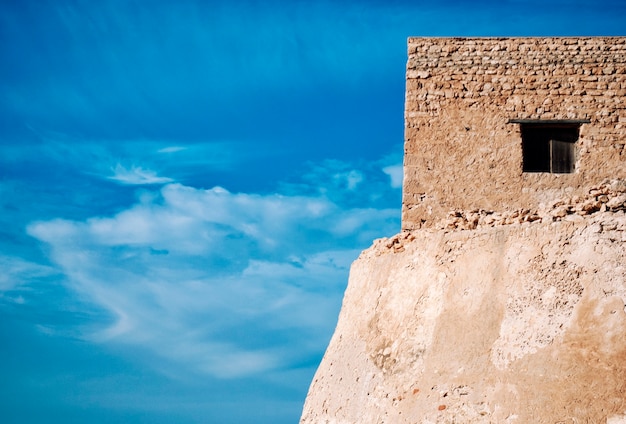 Old stone building against the blue sky at Tunisia.