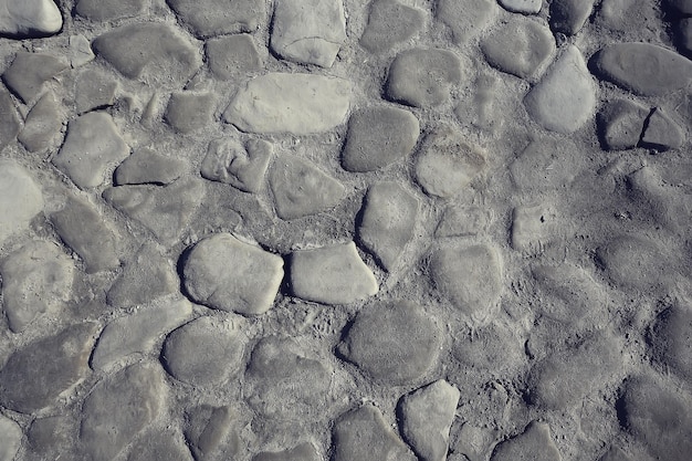 old stone pavement background / abstract pavement, large cobblestones, old road texture