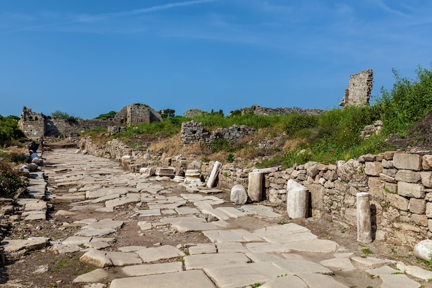 Old stone road with columns and ruins of the city of Side Turkey