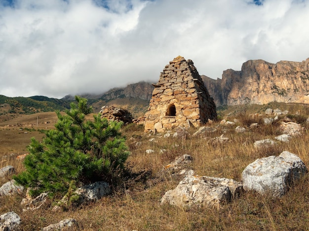 Old stone tomb a crypt on the top of a mountain Old Ossetian family crypt in the misty mountains Russia