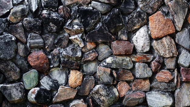 Old stone wall close up in soft beige palette with cement Stone wall surface background with detailed natural texture Historical building facade