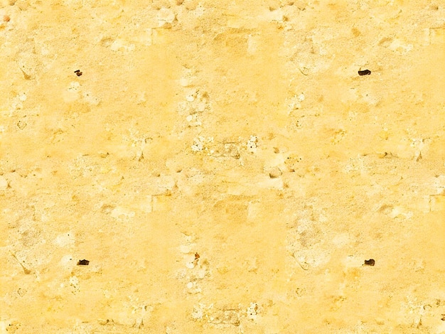 Photo old stone wall with light yellow plaster with cracks and stains from smudges seamless texture image