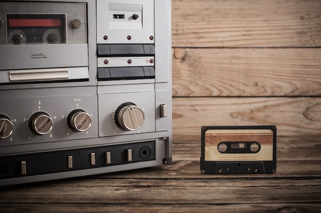 old tape recorder and cassette on  wooden background