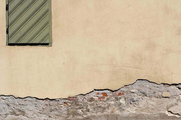 Old textured wall and wooden window