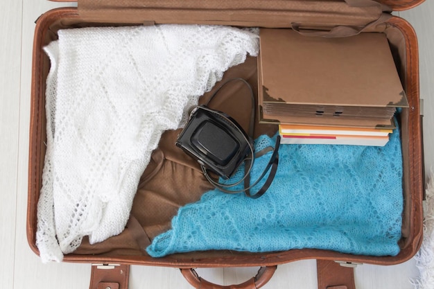 Old things folded in a retro suitcase for travel