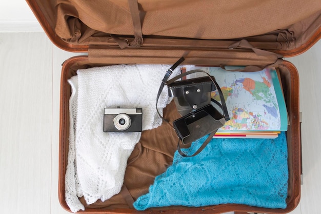 Old things folded in a retro suitcase for travel