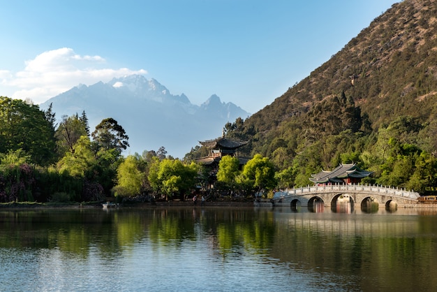 old town scene at Black Dragon Pool Park with Jade dragon mountain in background, Lijiang, China