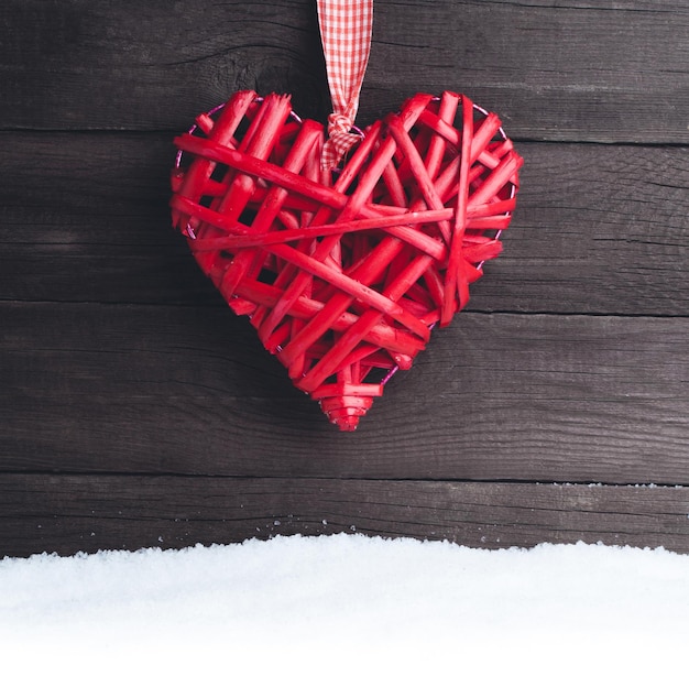 Old toy heart on a wooden background Valentine's Day card