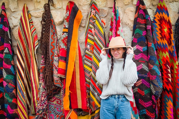 Old traditional Turkish carpet shop in cave house Cappadocia, Turkey Kapadokya. Young woman on vacation in Turkey