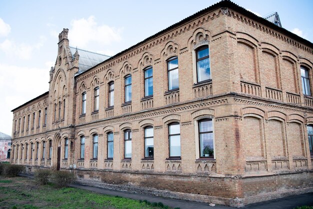 Old ukrainian historical building red brick school architecture attraction in a village or village outside the cityxA