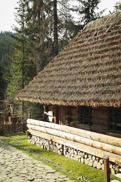 Old Ukrainian house in mountain resort park in autumn season