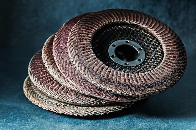 Old used abrasive flap discs on metalic background