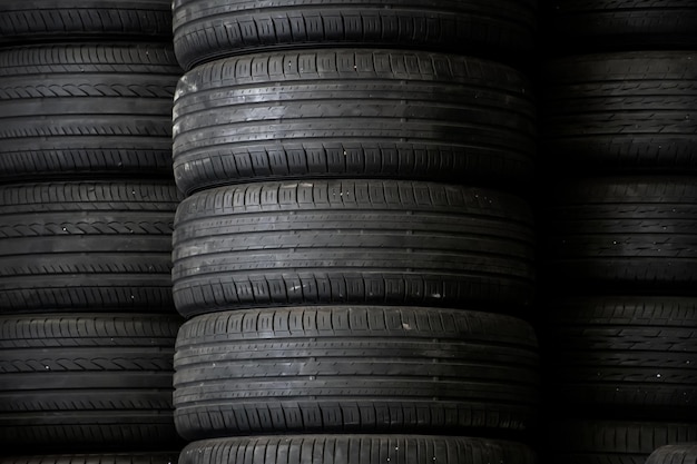 Old used car tires stacked in the repair garage