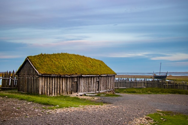 Old Viking Village ruins of Kattegatt  with black sand beach, viking boat, Atlantic Ocean Iceland