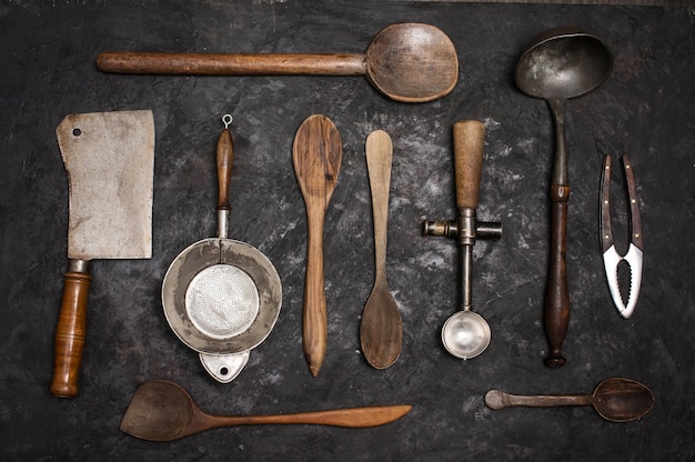 Old vintage kitchen utensils on black background