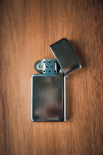 Old vintage lighter on a wooden background