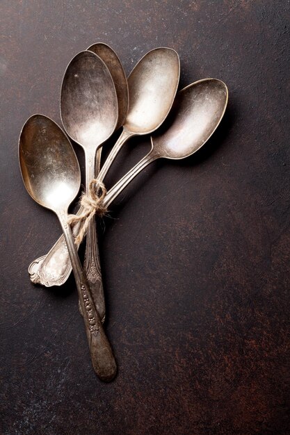 Old vintage spoons on stone table