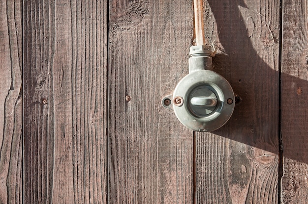 Old vintage switch on wood texture wall