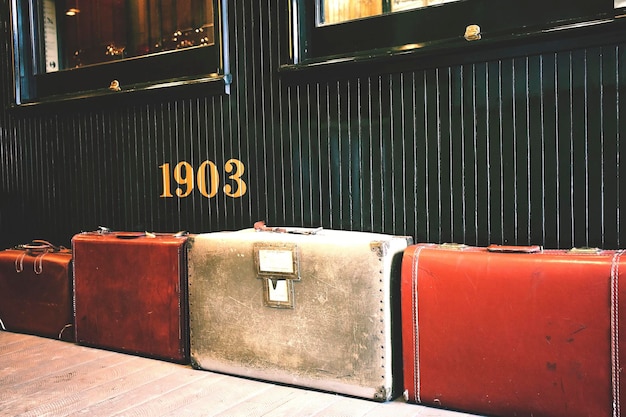 Old vintage train platform station with a lot of old luggage