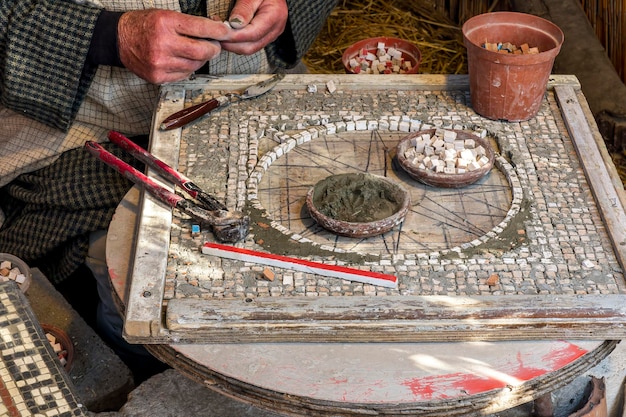 Old vintage workshop of mosaic craftsman with handicraft art hands doing daily work in a old rustic style