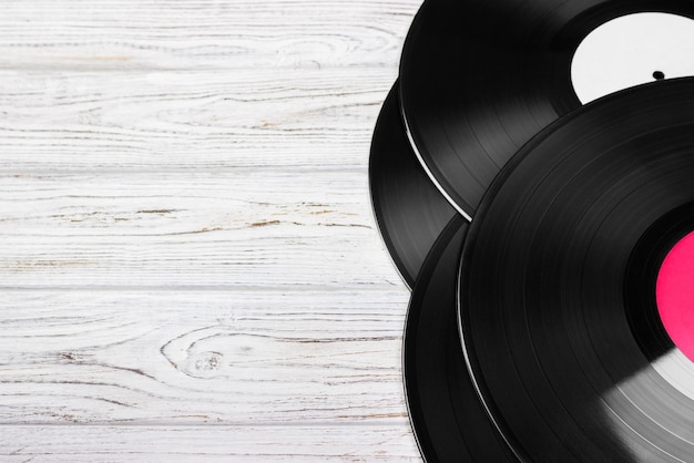 Old vinyl record on the bright wooden table selective focus and toned image Copy space