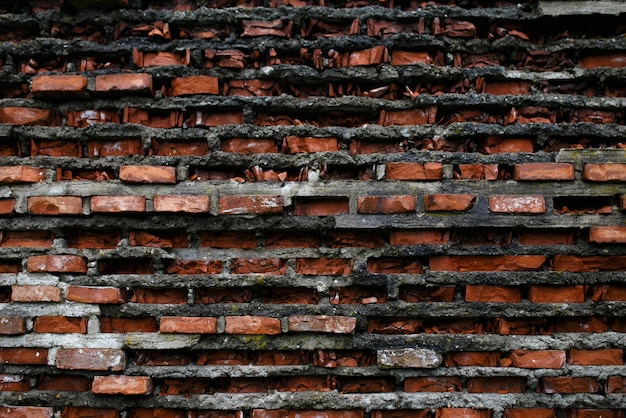 Old wall of broken bricks, wall of a collapsed building. Horizontal outside shot.