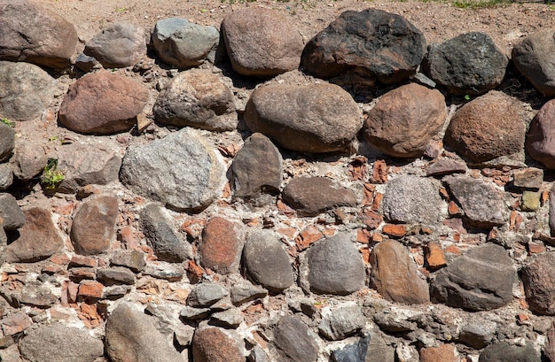 The old wall of the building is made of stones and cobblestones