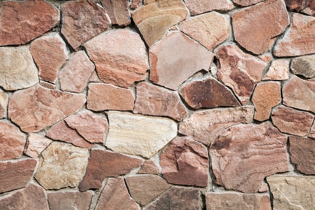 Old wall made of big stones and broken bricks