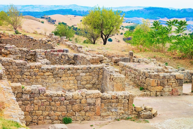 Old walls of buildings in Morgantina old town archaeological site, Sicily, Italy