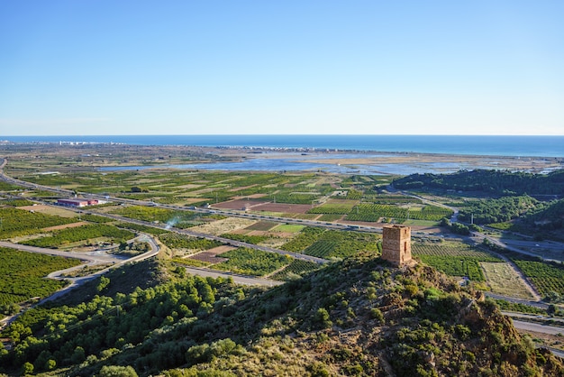 Old watchtower known as "l'Ageleta", orange-tree fields, wetlands and the Mediterranean Sea.