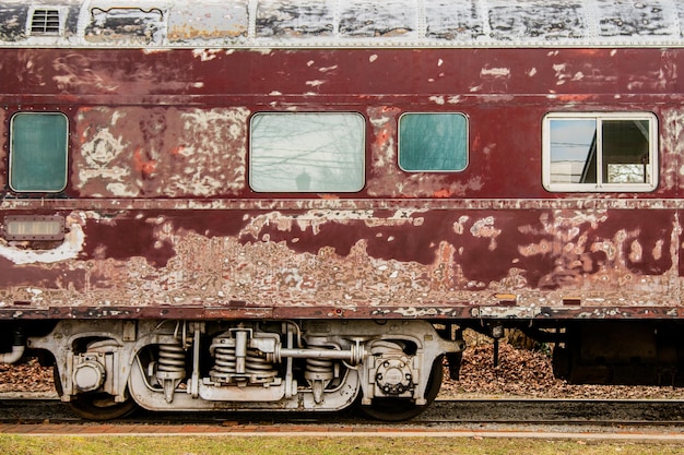 Old, weathered train railcar. Rusty train. Side view.