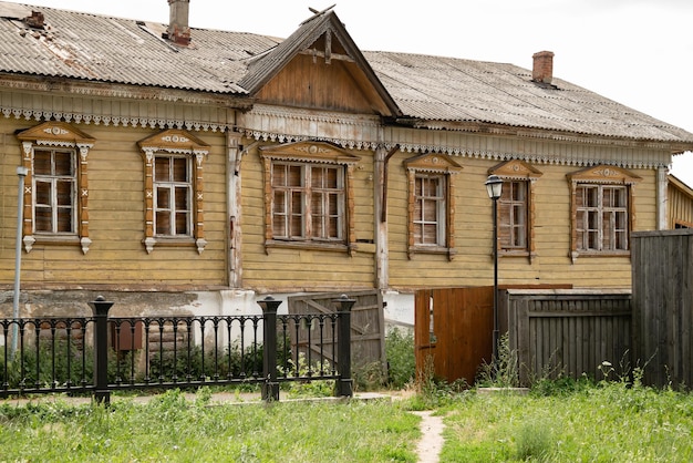 Old weathered wooden building with carved trims on windows