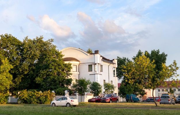 Old white cottage in cozy town Street view landscape old cirty little houses on sunset Old architecture front view