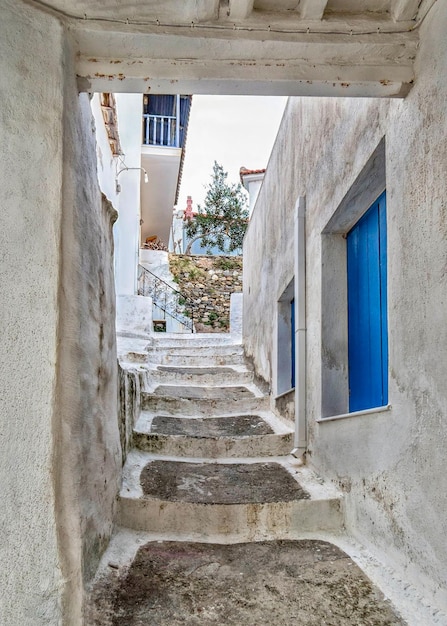 Old white houses in Cycladic style on the narrow streets of Skopelos island in Greece