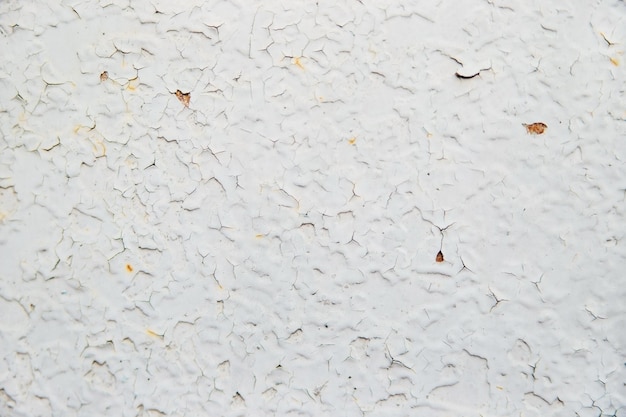 Old white metal background Uneven surface and texture of rusty metal Cracked paint