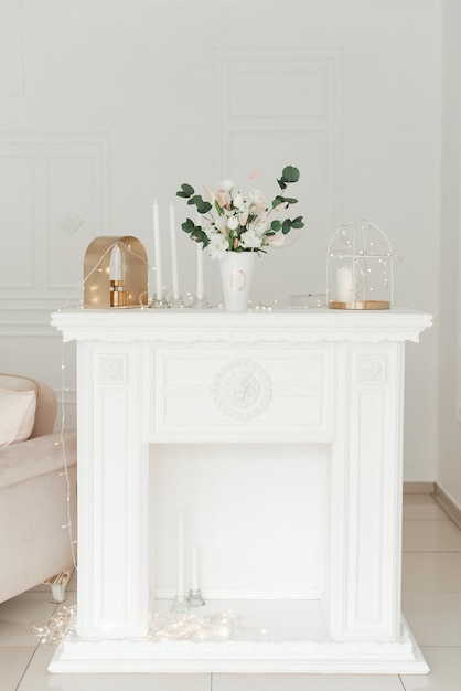 Old white vintage table decorated with flowers 