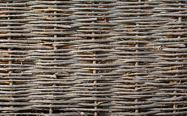 Old wicker fence texture close up selective focus