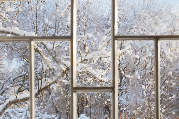 Old window with snowy beautiful landscape