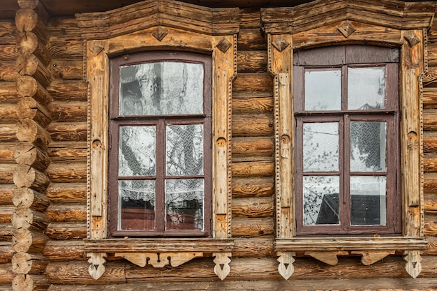 Old windows in a wooden log cabin