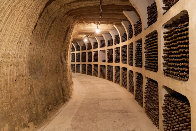 Old wine cellar with stacks of old wine bottlesOld wine bottles are stacked in rows in the cellars of the winery